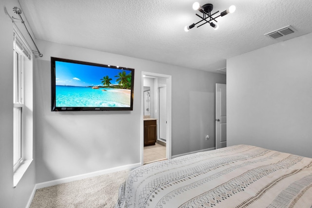 6340 Sailpointe Ln, West Palm Beach, FL 33413 - bedroom featuring baseboards, light colored carpet, a textured ceiling, and ensuite bathroom