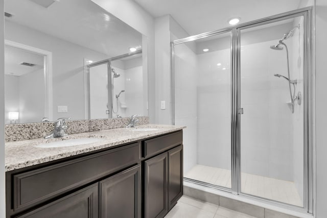 6340 Sailpointe Ln, West Palm Beach, FL 33413 - full bath featuring a stall shower, double vanity, and tile patterned floors