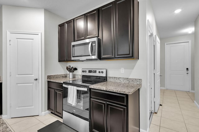 6340 Sailpointe Ln, West Palm Beach, FL 33413 - kitchen with stainless steel appliances, light tile patterned floors, baseboards, dark brown cabinets, and recessed lighting