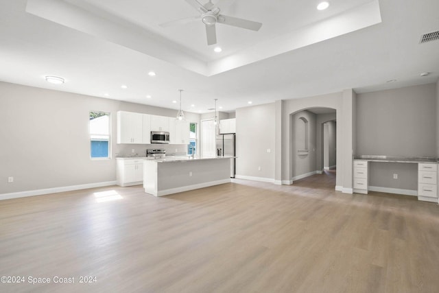 181 Ferguson St SE, Palm Bay, FL 32909 - unfurnished living room featuring arched walkways, recessed lighting, light wood-type flooring, a ceiling fan, and baseboards