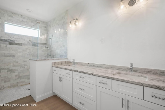 181 Ferguson St SE, Palm Bay, FL 32909 - bathroom with a walk in shower, double vanity, and wood finished floors