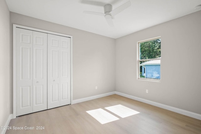 181 Ferguson St SE, Palm Bay, FL 32909 - unfurnished bedroom with wood finished floors, a closet, baseboards, and a ceiling fan
