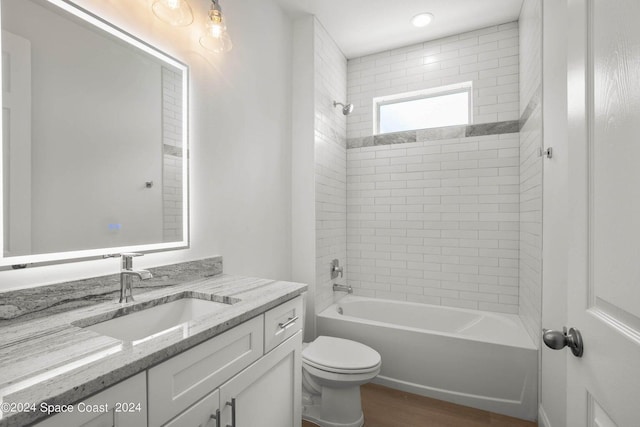 181 Ferguson St SE, Palm Bay, FL 32909 - bathroom featuring vanity, toilet, tub / shower combination, and wood finished floors