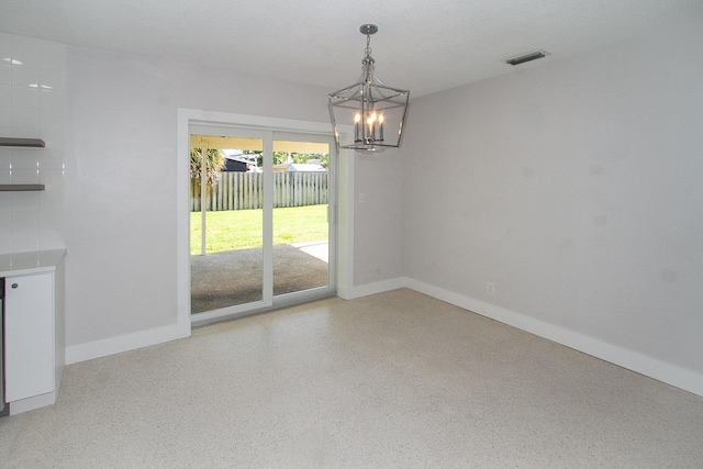 214 SW 3rd St, Boca Raton, FL 33432 - unfurnished dining area featuring a chandelier, speckle patterned floor, and baseboards