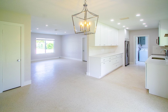 214 SW 3rd St, Boca Raton, FL 33432 - kitchen with washer / dryer, a sink, appliances with stainless steel finishes, light countertops, and recessed lighting
