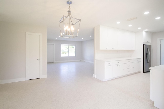 214 SW 3rd St, Boca Raton, FL 33432 - kitchen with stainless steel refrigerator with ice dispenser, a chandelier, white cabinetry, light countertops, and baseboards