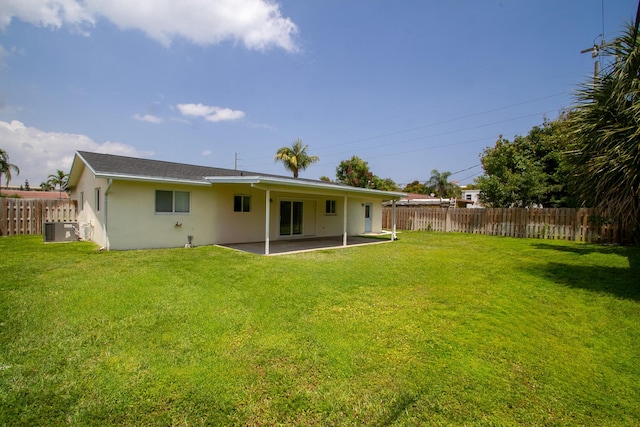 214 SW 3rd St, Boca Raton, FL 33432 - back of property featuring stucco siding, central AC, and a patio