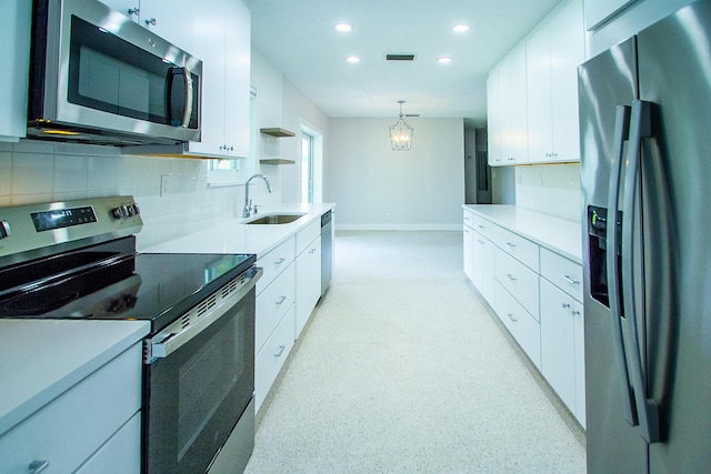 214 SW 3rd St, Boca Raton, FL 33432 - kitchen with stainless steel appliances, a sink, recessed lighting, backsplash, and white cabinets