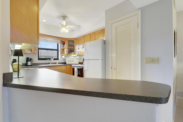 755 Saturn St Unit E 202, Jupiter, FL 33477 - kitchen with white appliances, a sink, dark countertops, a ceiling fan, and under cabinet range hood