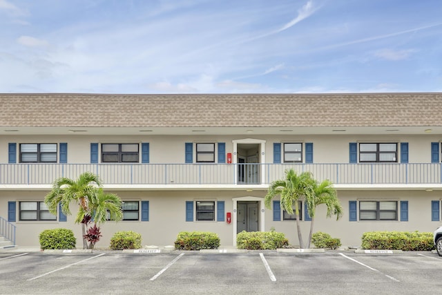 755 Saturn St Unit E 202, Jupiter, FL 33477 - view of building exterior with uncovered parking