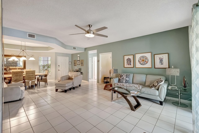 11650 Briarwood Cir Unit 2, Boynton Beach, FL 33437 - living room with ceiling fan, a textured ceiling, light tile patterned floors, and baseboards