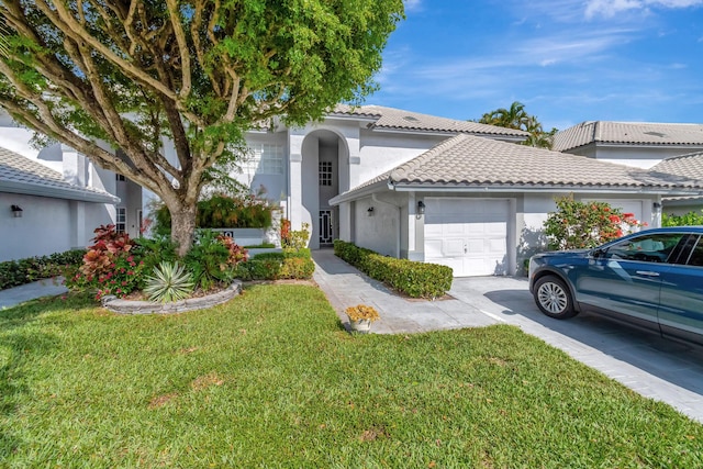 11650 Briarwood Cir Unit 2, Boynton Beach, FL 33437 - view of front of property with a garage, a tiled roof, stucco siding, a front lawn, and driveway