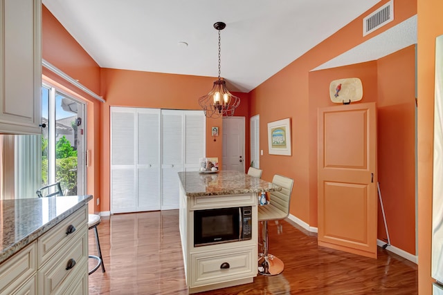 11650 Briarwood Cir Unit 2, Boynton Beach, FL 33437 - dining space featuring a chandelier, baseboards, light wood finished floors, and lofted ceiling