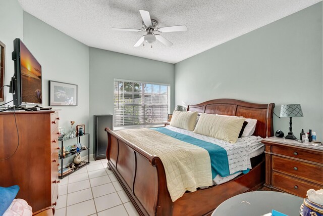 11650 Briarwood Cir Unit 2, Boynton Beach, FL 33437 - bedroom with a textured ceiling, light tile patterned flooring, ceiling fan, and baseboards