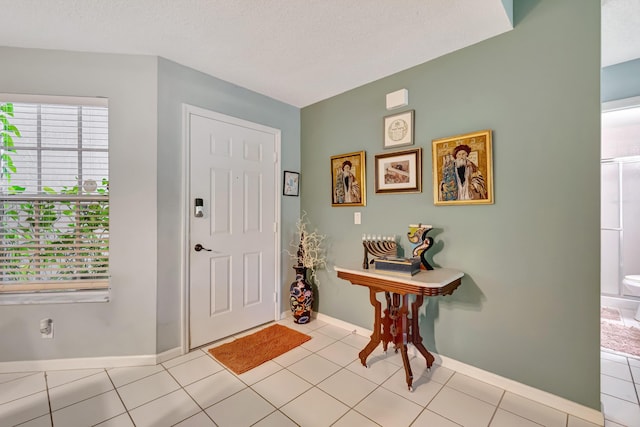 11650 Briarwood Cir Unit 2, Boynton Beach, FL 33437 - foyer with light tile patterned flooring and baseboards