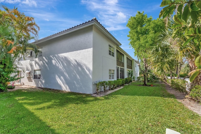 11650 Briarwood Cir Unit 2, Boynton Beach, FL 33437 - view of side of home with stucco siding and a lawn