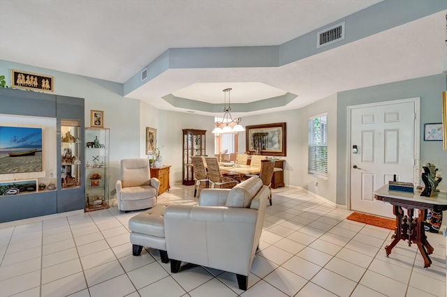 11650 Briarwood Cir Unit 2, Boynton Beach, FL 33437 - living area with light tile patterned flooring, a tray ceiling, a chandelier, and baseboards