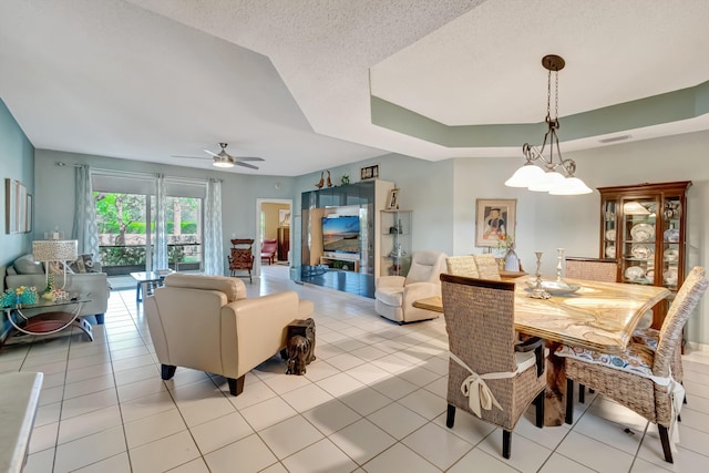 11650 Briarwood Cir Unit 2, Boynton Beach, FL 33437 - dining room featuring ceiling fan, light tile patterned flooring, and a tray ceiling