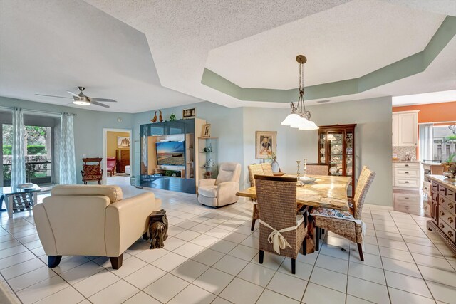 11650 Briarwood Cir Unit 2, Boynton Beach, FL 33437 - dining area with light tile patterned flooring, a ceiling fan, and a raised ceiling