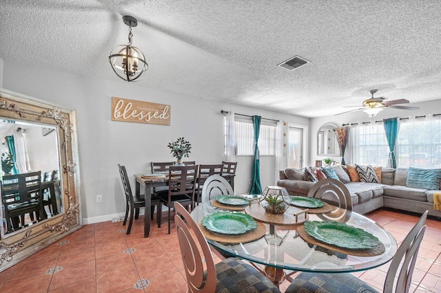 1441 W Hardee St, Lantana, FL 33462 - dining area with light tile patterned floors, a ceiling fan, a chandelier, a textured ceiling, and baseboards