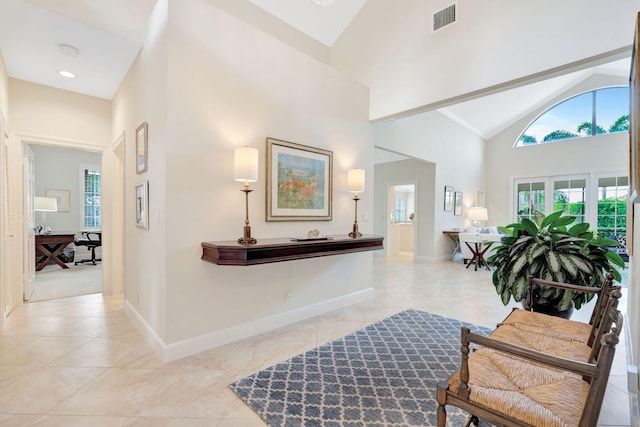 3321 Southern Cay Dr, Jupiter, FL 33477 - hall featuring high vaulted ceiling, light tile patterned flooring, and baseboards