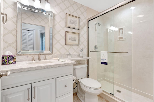 3321 Southern Cay Dr, Jupiter, FL 33477 - bathroom featuring a stall shower, toilet, vanity, and wallpapered walls