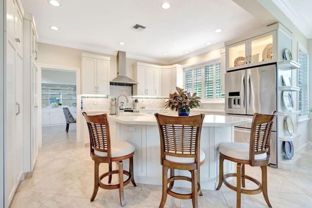 3321 Southern Cay Dr, Jupiter, FL 33477 - kitchen featuring wall chimney exhaust hood, a kitchen island with sink, light countertops, a breakfast bar, and recessed lighting
