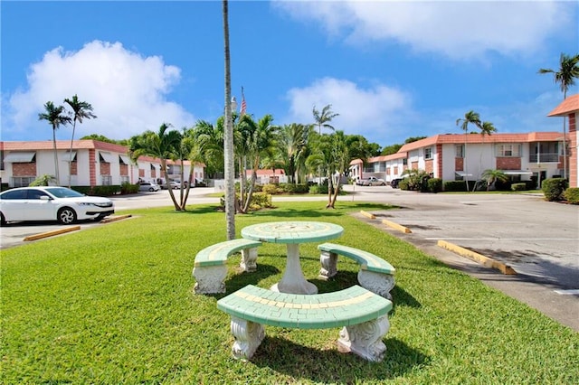 3550 NW 8th Ave Unit 604, Pompano Beach, FL 33064 - view of community with a residential view, a lawn, and uncovered parking