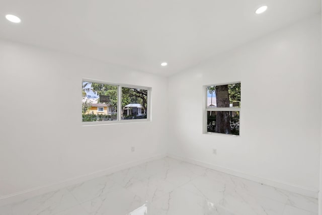 1530 NW 18th Ct, Fort Lauderdale, FL 33311 - empty room with baseboards, healthy amount of natural light, recessed lighting, and light marble finish floors
