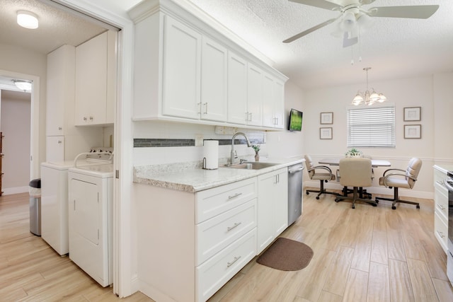 3326 Arcara Way Unit 416, Lake Worth, FL 33467 - kitchen featuring a sink, stainless steel dishwasher, independent washer and dryer, light wood-style flooring, and a textured ceiling
