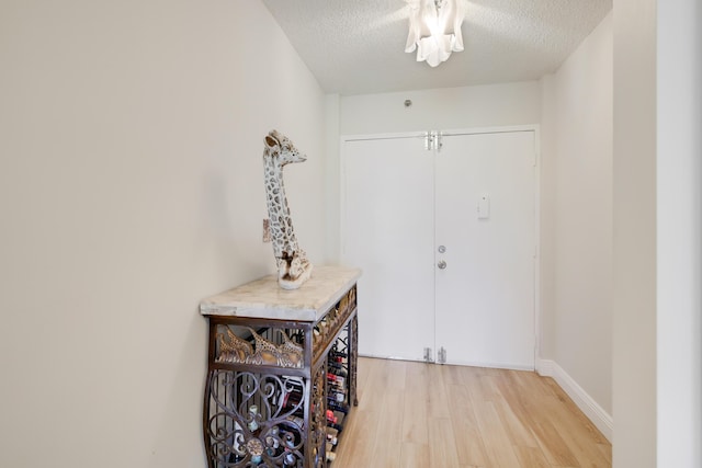 3326 Arcara Way Unit 416, Lake Worth, FL 33467 - foyer with light wood-style flooring, a textured ceiling, and baseboards