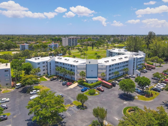 3326 Arcara Way Unit 416, Lake Worth, FL 33467 - drone / aerial view of apartment complex, a tree filled landscape, and a local golf course