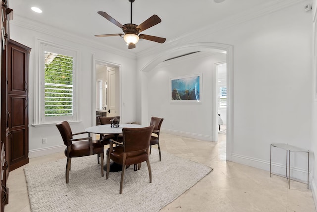 9212 Perth Rd, Lake Worth, FL 33467 - dining room featuring ornamental molding, arched walkways, a ceiling fan, and baseboards