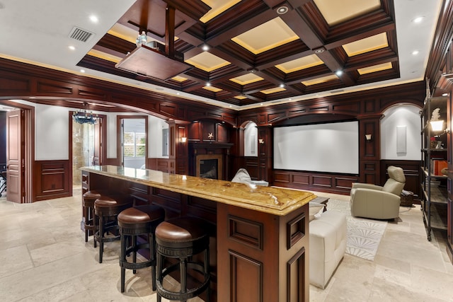 9212 Perth Rd, Lake Worth, FL 33467 - home theater featuring a decorative wall, coffered ceiling, crown molding, a fireplace, and stone tile floors