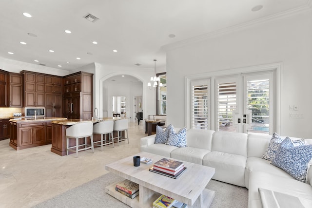9212 Perth Rd, Lake Worth, FL 33467 - living area with crown molding, arched walkways, recessed lighting, and a chandelier
