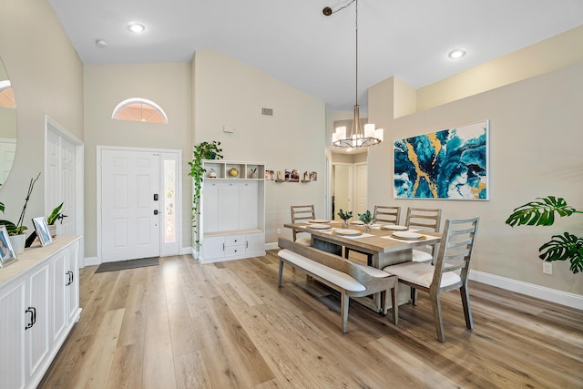 10560 Plainview Cir, Boca Raton, FL 33498 - dining room with a towering ceiling, baseboards, a chandelier, and light wood-type flooring