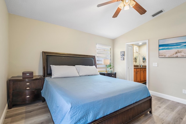 10560 Plainview Cir, Boca Raton, FL 33498 - bedroom with wood finished floors, baseboards, vaulted ceiling, ensuite bath, and a ceiling fan