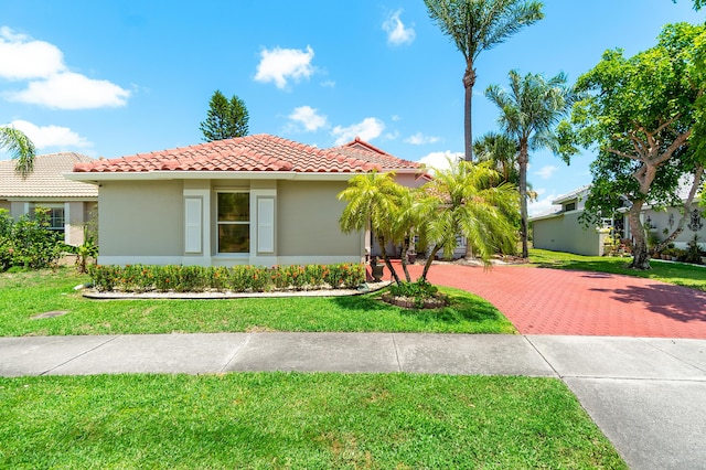10560 Plainview Cir, Boca Raton, FL 33498 - mediterranean / spanish home featuring a tiled roof, stucco siding, and a front lawn