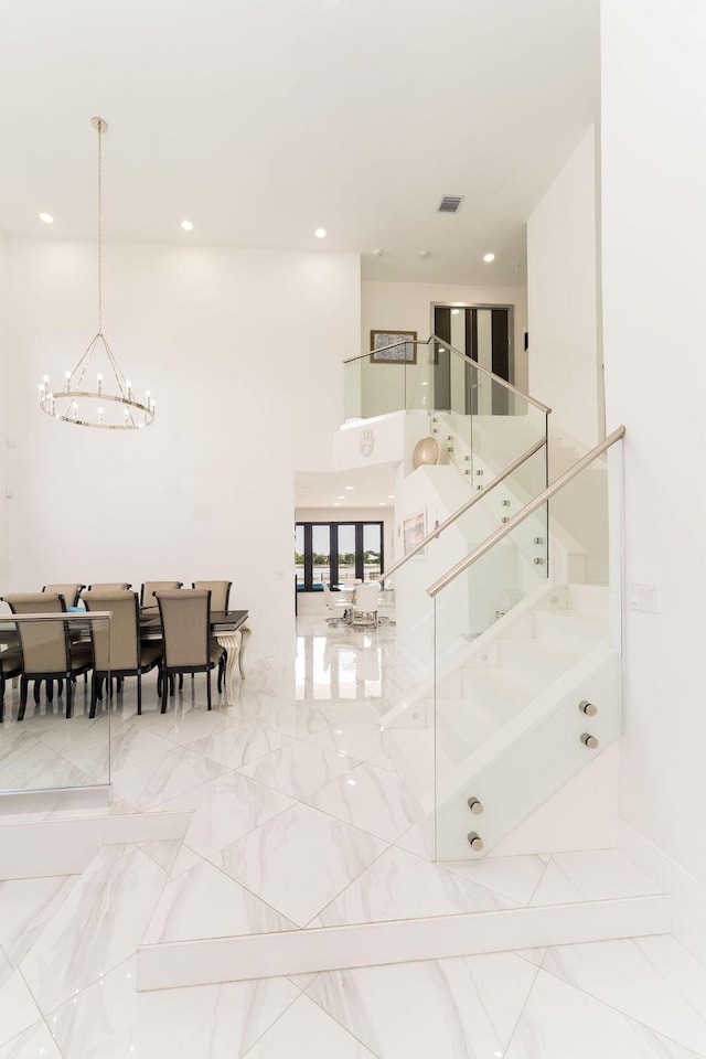 9475 Equus Cir, Boynton Beach, FL 33472 - stairway featuring a chandelier, recessed lighting, and a high ceiling