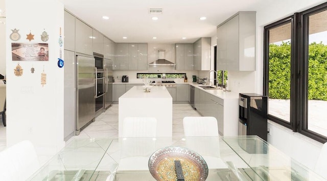 9475 Equus Cir, Boynton Beach, FL 33472 - kitchen with gray cabinetry, modern cabinets, a sink, built in appliances, and recessed lighting