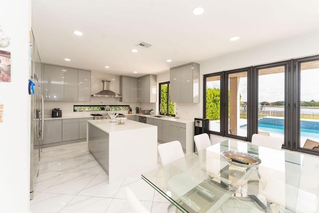 9475 Equus Cir, Boynton Beach, FL 33472 - kitchen featuring gray cabinetry, modern cabinets, wall chimney range hood, light countertops, and recessed lighting