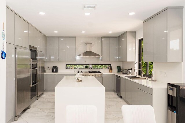 9475 Equus Cir, Boynton Beach, FL 33472 - kitchen featuring gray cabinetry, modern cabinets, wall chimney range hood, appliances with stainless steel finishes, and a sink