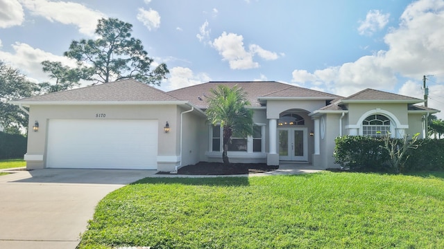 5170 NW Aljo Ct, Port Saint Lucie, FL 34986 - view of front of property featuring french doors, stucco siding, a front yard, and driveway