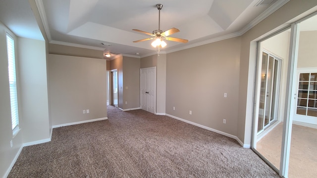 5170 NW Aljo Ct, Port Saint Lucie, FL 34986 - carpeted spare room featuring a tray ceiling, ceiling fan, baseboards, and ornamental molding