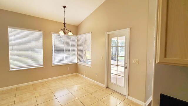 5170 NW Aljo Ct, Port Saint Lucie, FL 34986 - unfurnished dining area with a chandelier, lofted ceiling, baseboards, and light tile patterned floors