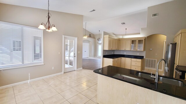 5170 NW Aljo Ct, Port Saint Lucie, FL 34986 - kitchen featuring arched walkways, light brown cabinets, freestanding refrigerator, a sink, and plenty of natural light