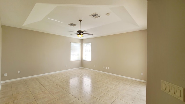 5170 NW Aljo Ct, Port Saint Lucie, FL 34986 - unfurnished room with a raised ceiling, a ceiling fan, baseboards, and light tile patterned floors