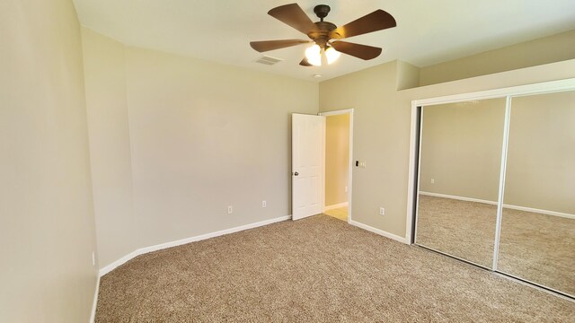 5170 NW Aljo Ct, Port Saint Lucie, FL 34986 - unfurnished bedroom featuring carpet flooring, a closet, baseboards, and a ceiling fan