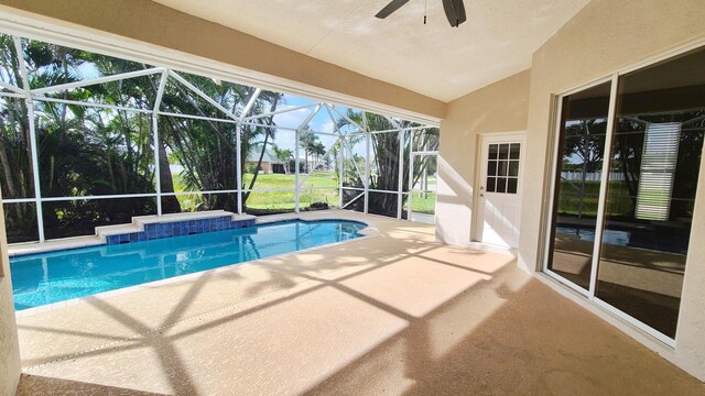5170 NW Aljo Ct, Port Saint Lucie, FL 34986 - swimming pool with a patio, ceiling fan, and glass enclosure