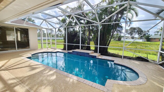 5170 NW Aljo Ct, Port Saint Lucie, FL 34986 - outdoor pool with glass enclosure, a patio area, and a yard